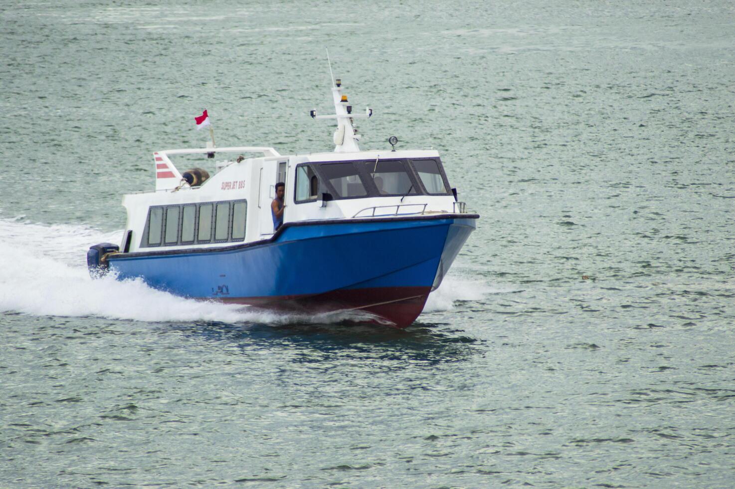 Batam, Indonesia - 8 July 2024. view of a passenger speed boat traveling fast photo