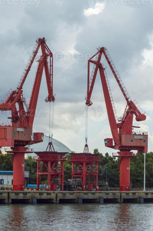 Batam, Indonesia. 7 July 2024. Grab crane, a tool used for loading and unloading cargo from ships. photo