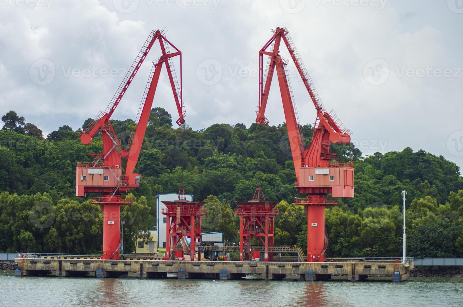 Batam, Indonesia. 7 July 2024. Grab crane, a tool used for loading and unloading cargo from ships. photo