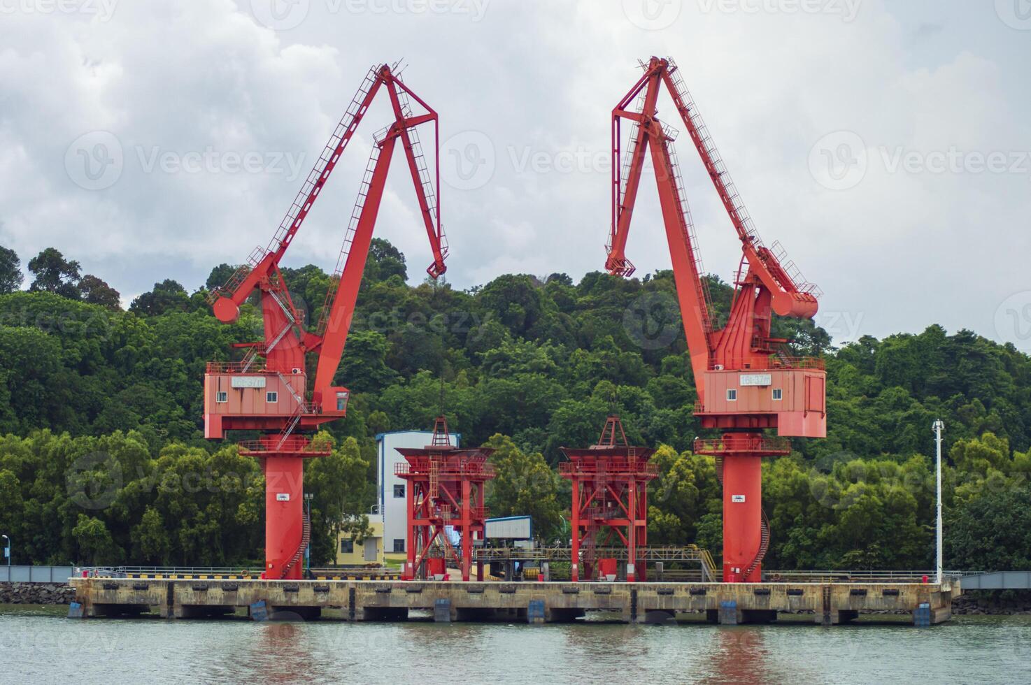 Batam, Indonesia. 7 July 2024. Grab crane, a tool used for loading and unloading cargo from ships. photo