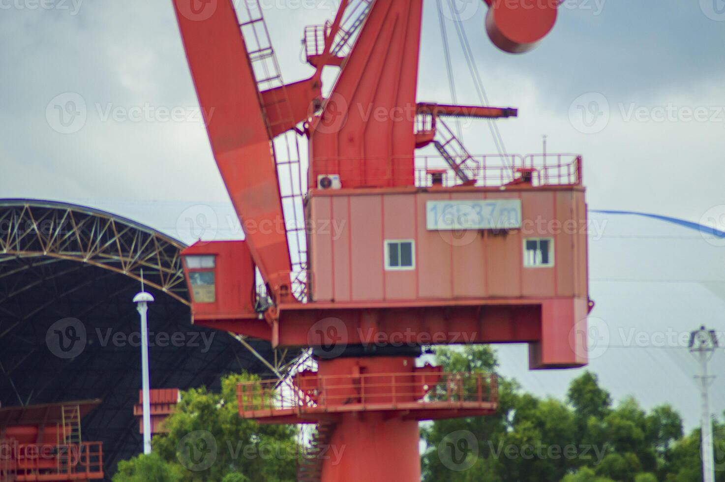 Batam, Indonesia. 7 July 2024. Grab crane, a tool used for loading and unloading cargo from ships. photo
