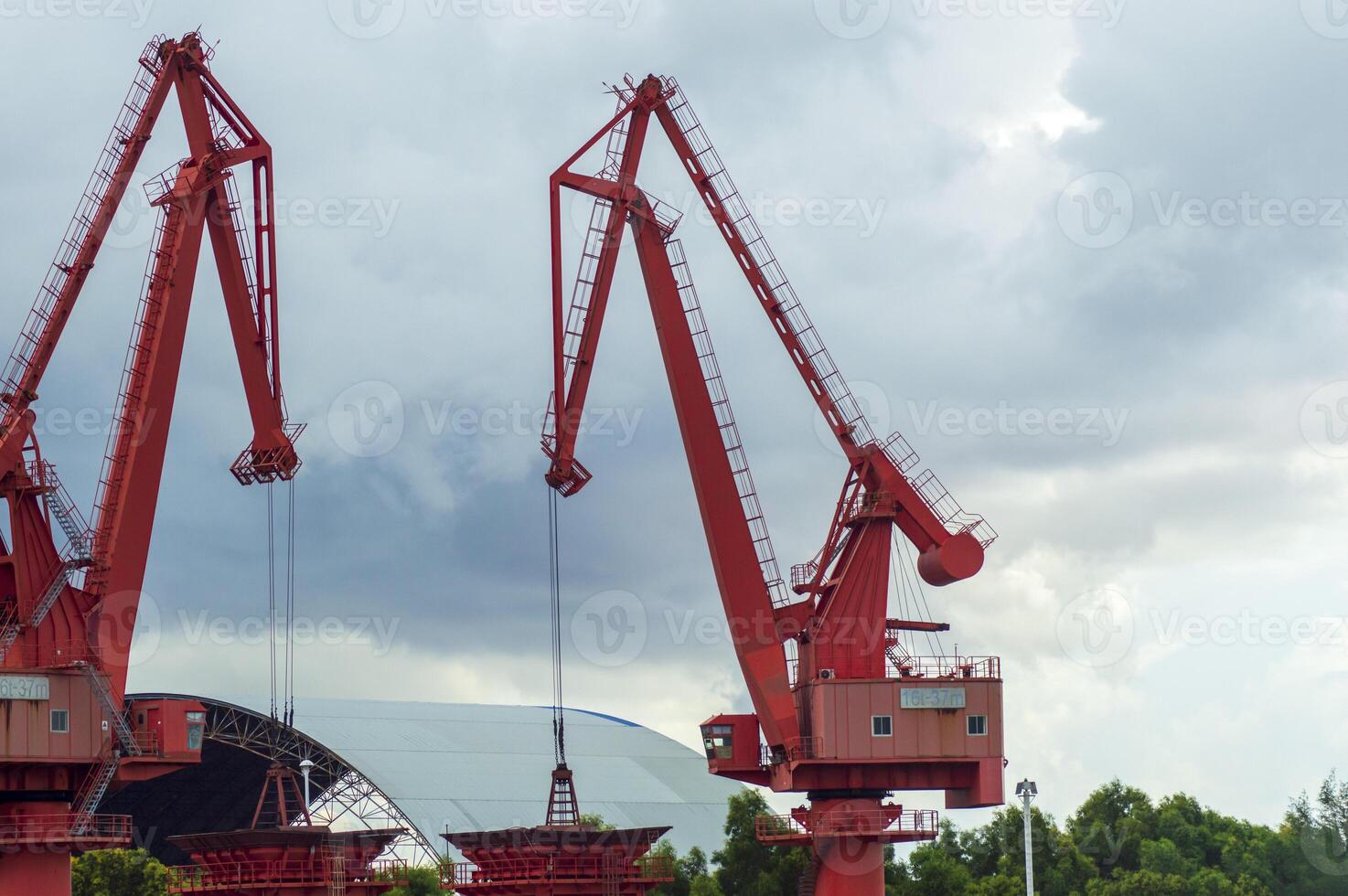 Batam, Indonesia. 7 July 2024. Grab crane, a tool used for loading and unloading cargo from ships. photo