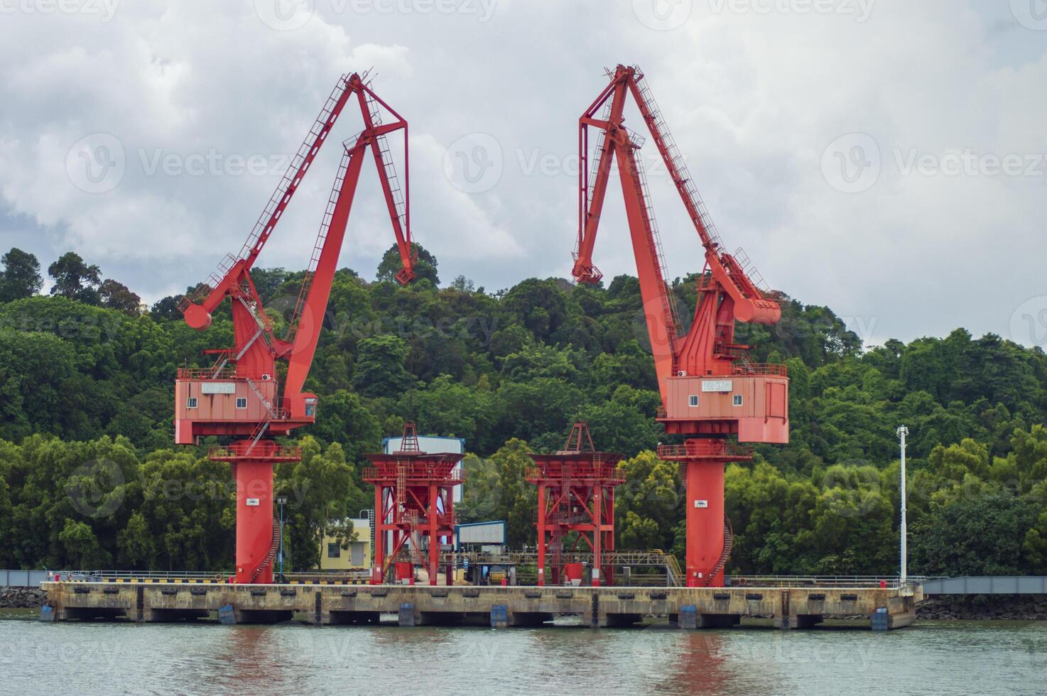 Batam, Indonesia. 7 July 2024. Grab crane, a tool used for loading and unloading cargo from ships. photo