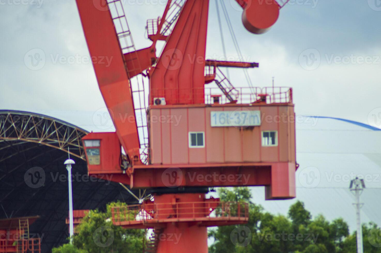 Batam, Indonesia. 7 July 2024. Grab crane, a tool used for loading and unloading cargo from ships. photo