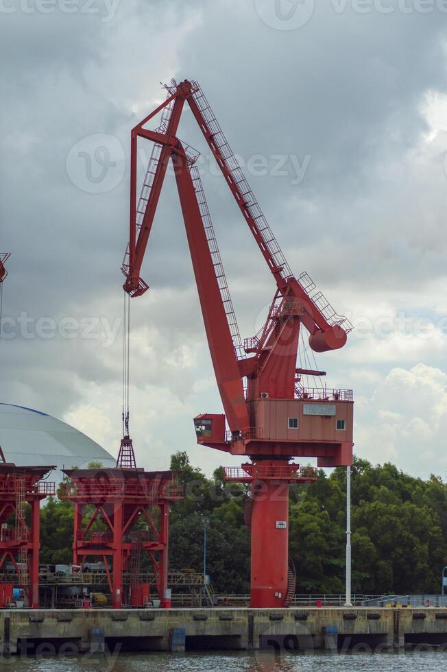 Batam, Indonesia. 7 July 2024. Grab crane, a tool used for loading and unloading cargo from ships. photo