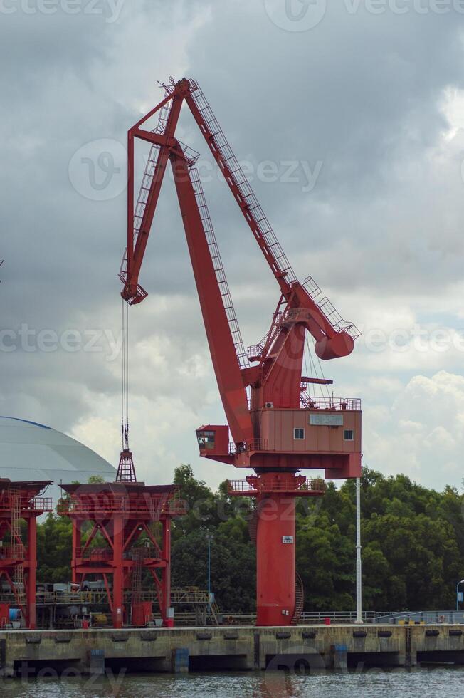 Batam, Indonesia. 7 July 2024. Grab crane, a tool used for loading and unloading cargo from ships. photo