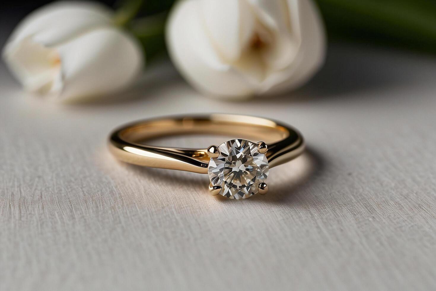 an elegant diamond engagement ring with a prominent solitaire, set on a slender gold band. The textured grey background adds a touch of sophistication photo