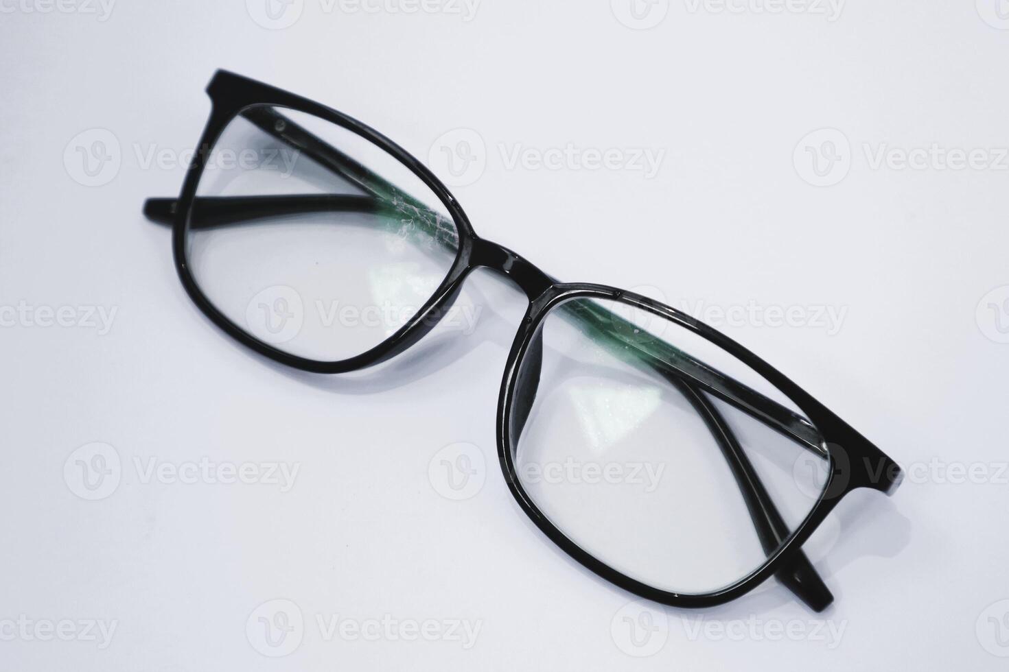 Simple black eyeglass frames with a plain background photo