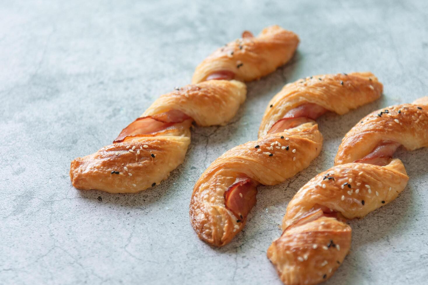 Homemade bacon bread twists on stone background, space for texture photo