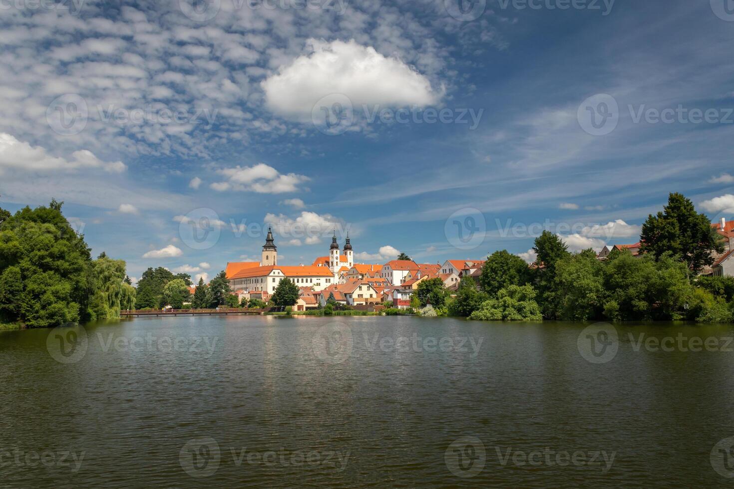 Telc cityscape in Czech republic, in the background Church of the Name of Jesus, in the foreground pond Ulicky photo