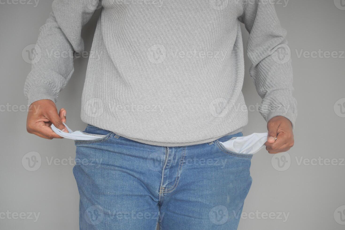 young man shows empty pant pocket with copy space photo