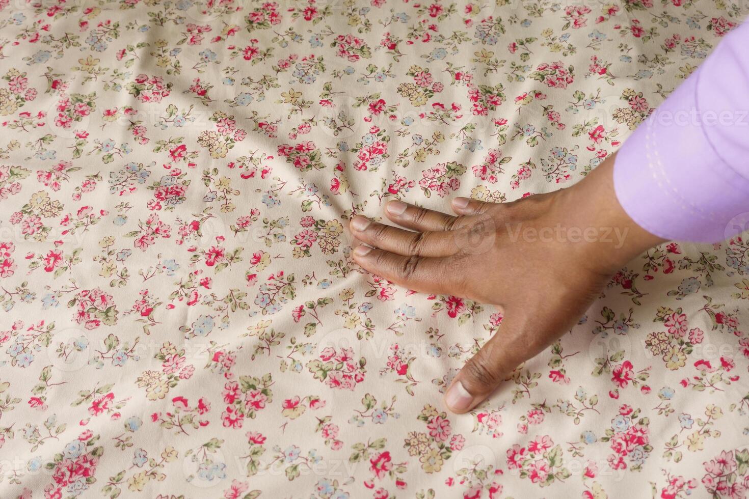 man Hand touching and pressing orthopedic mattress on bed. photo