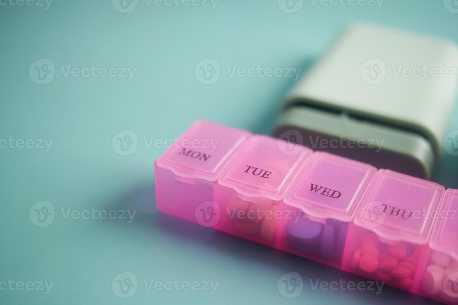 close up of medical pills in a pill box on table photo