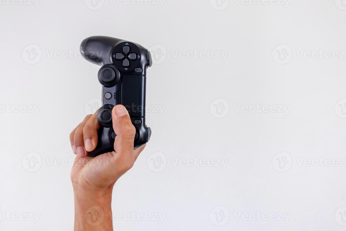Hand holding a gamepad controller or joystick on a white background photo