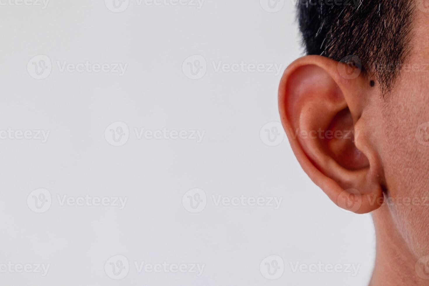 Close up view of a man's ear on white background. Copy space. photo