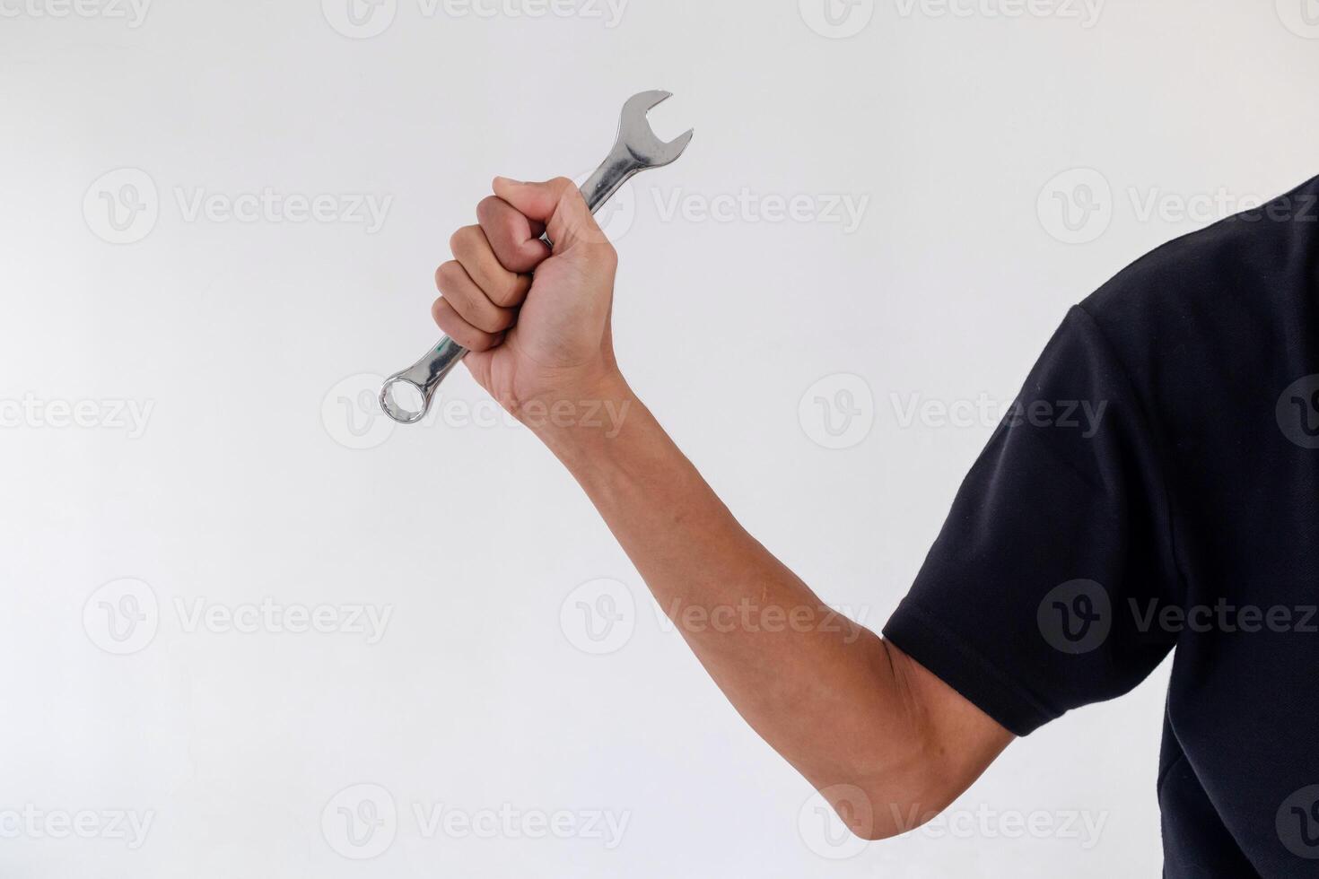 Man holding a wrench or spanner on a white background photo