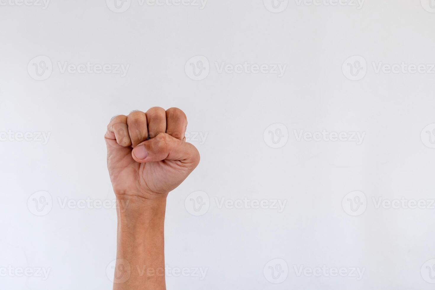 Male clenched fist isolated on a white background. Copy space. photo