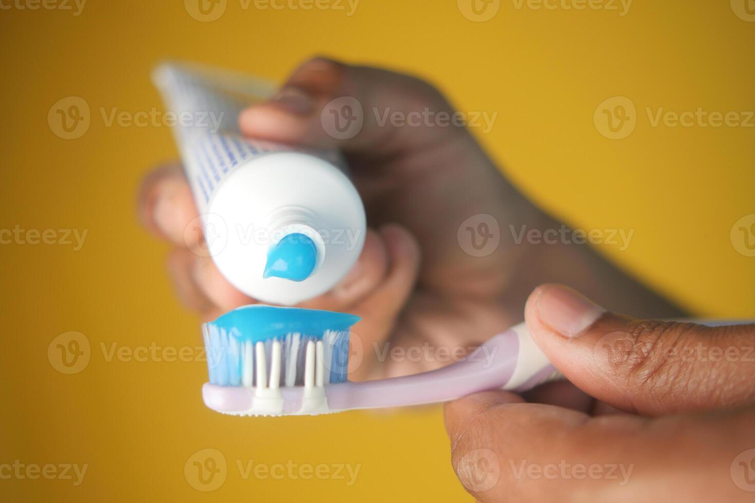 hand holding tooth brush with paste photo