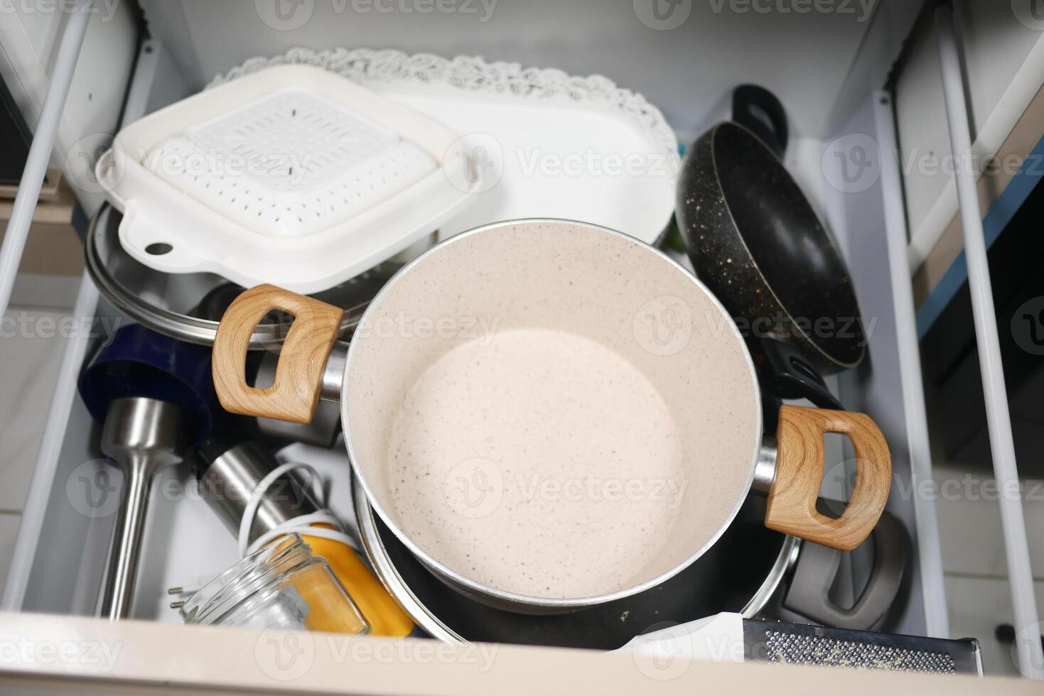 A kitchen drawer full of various utensils and cookware for storage and organization in the household photo