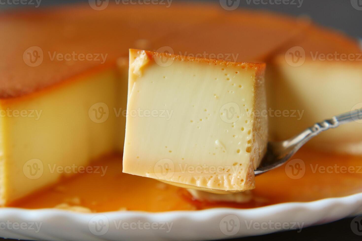 Caramel custard pudding on a plate on table photo