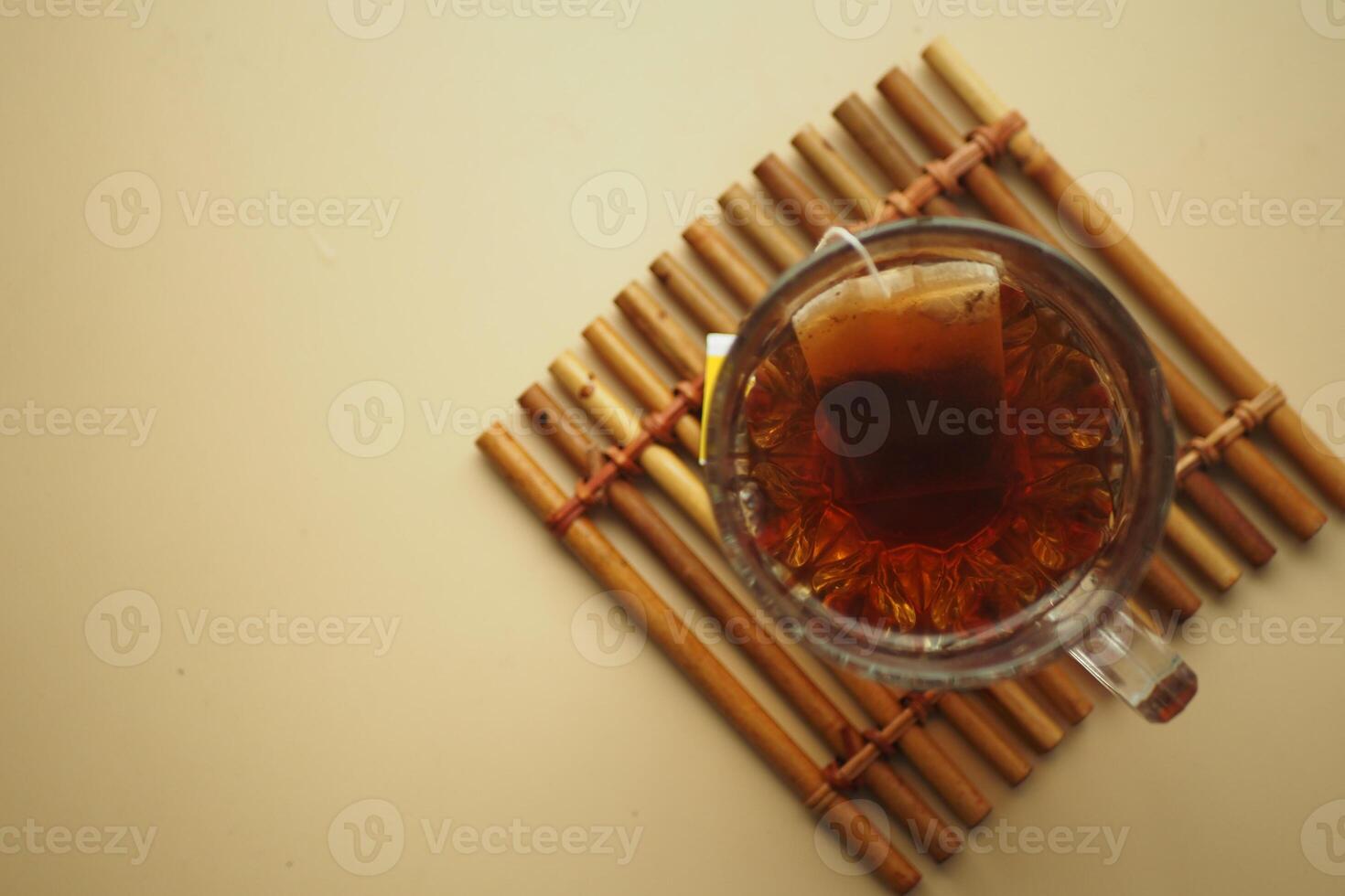 Cup of tea with tea bag on wooden table close-up. photo