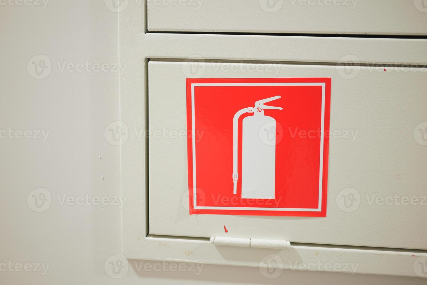 The store aisle is marked with a sign indicating the presence of a fire extinguisher and fire hose photo