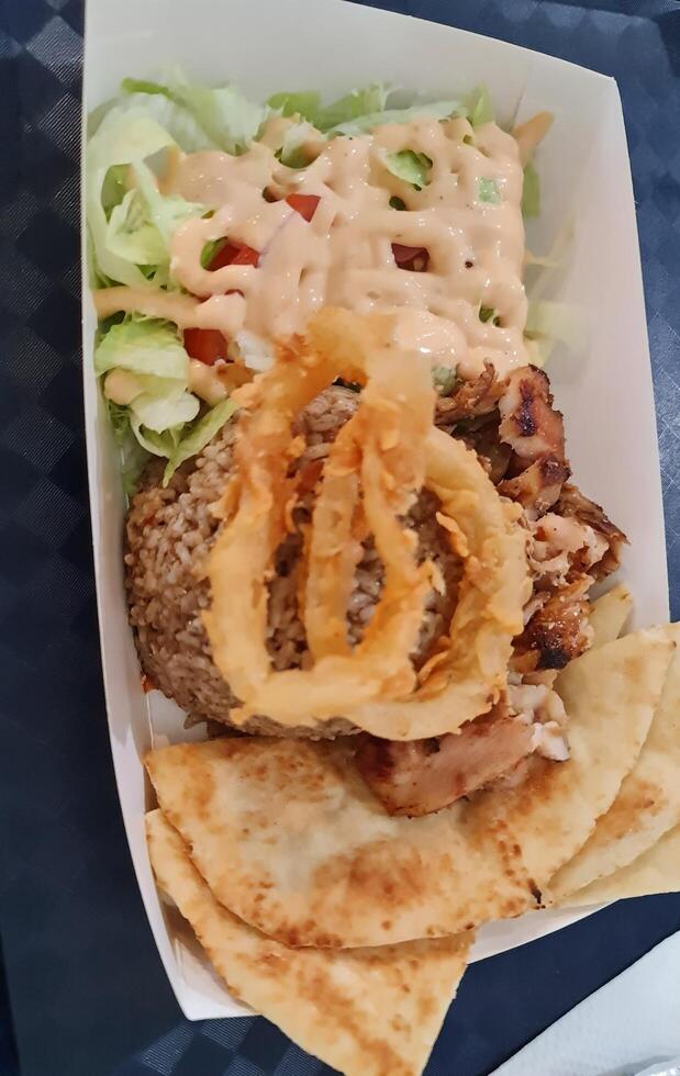 The food was bought from Doner Kebab, which contained briyani rice, roti canai, photo