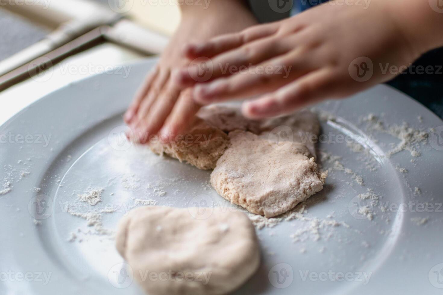 Child having fun modeling salt dough, authentic activity, fine motor skills development photo