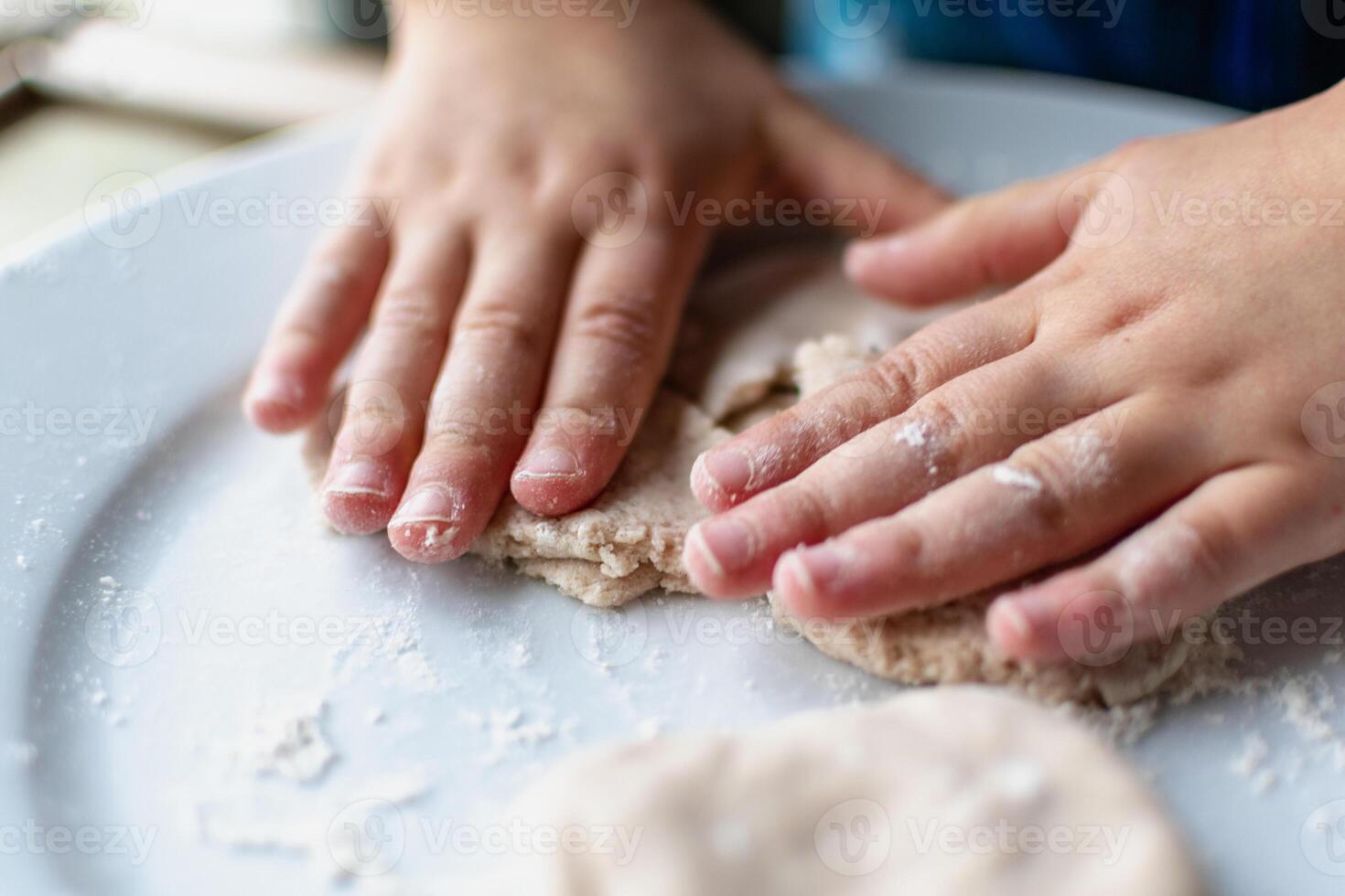 Child having fun modeling salt dough, authentic activity, fine motor skills development photo