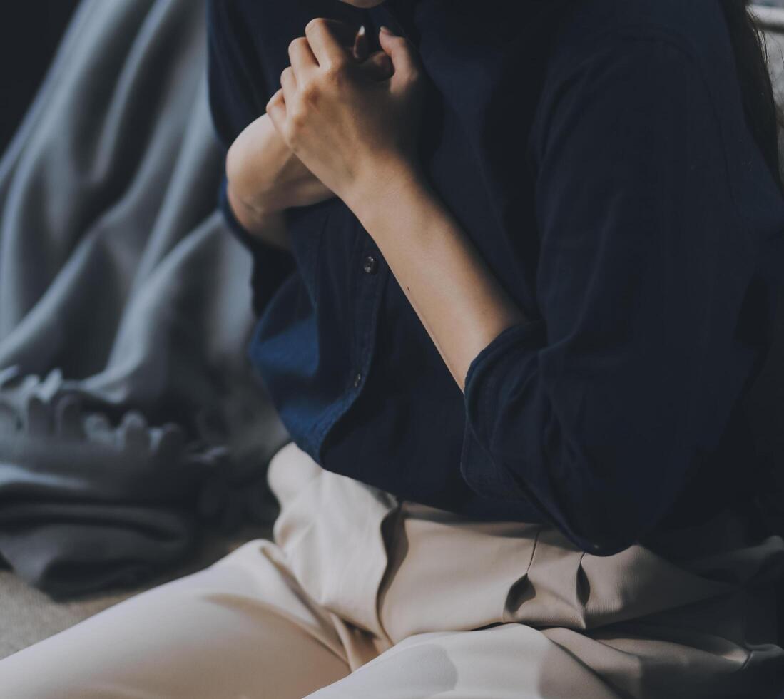 A woman with a cold with pills is treated at home chooses which drugs to take and self-medicates, checks the expiration date while sitting on the couch at home photo