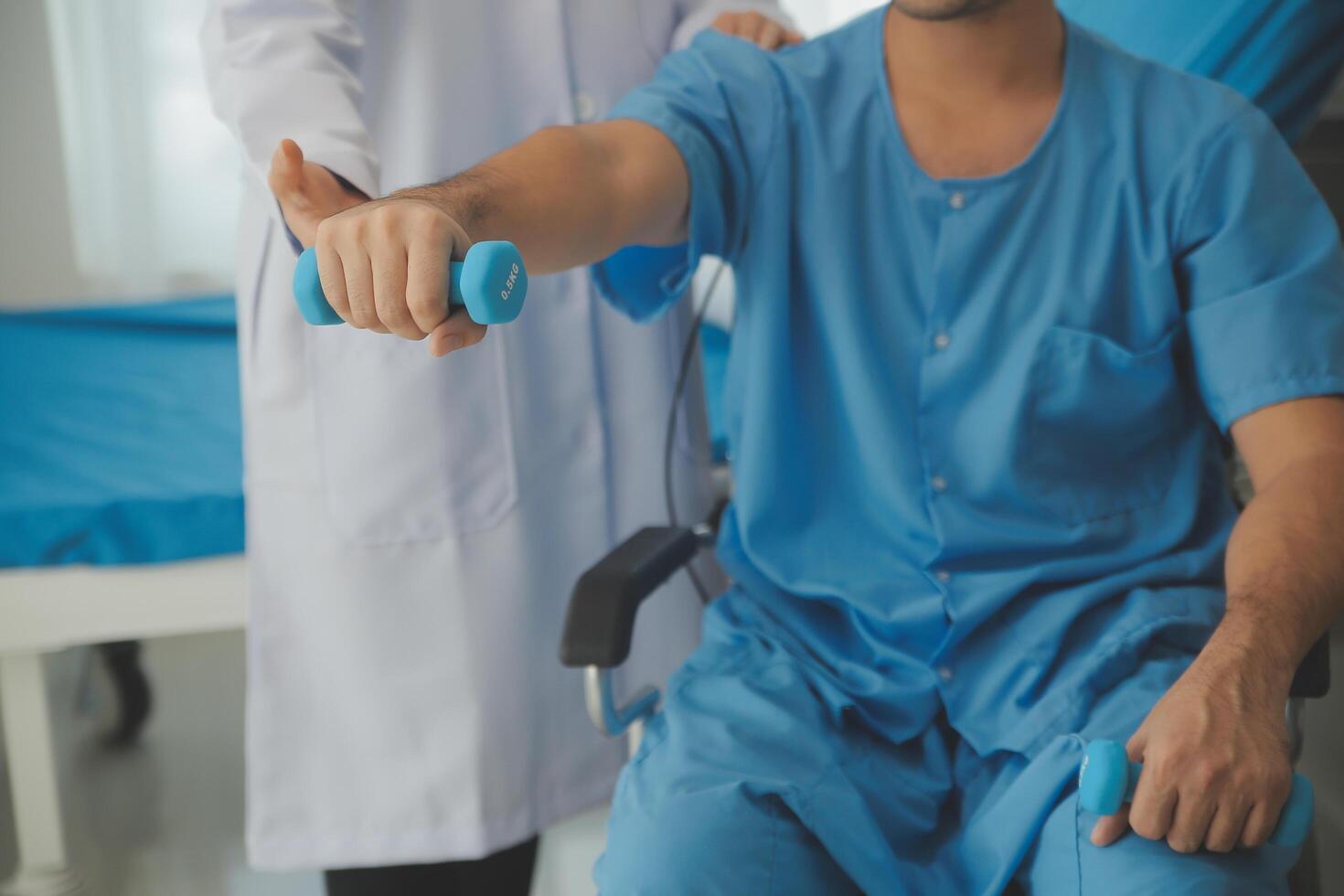 Physiotherapist man giving exercise with dumbbell treatment About Arm and Shoulder of athlete male patient Physical therapy concept photo