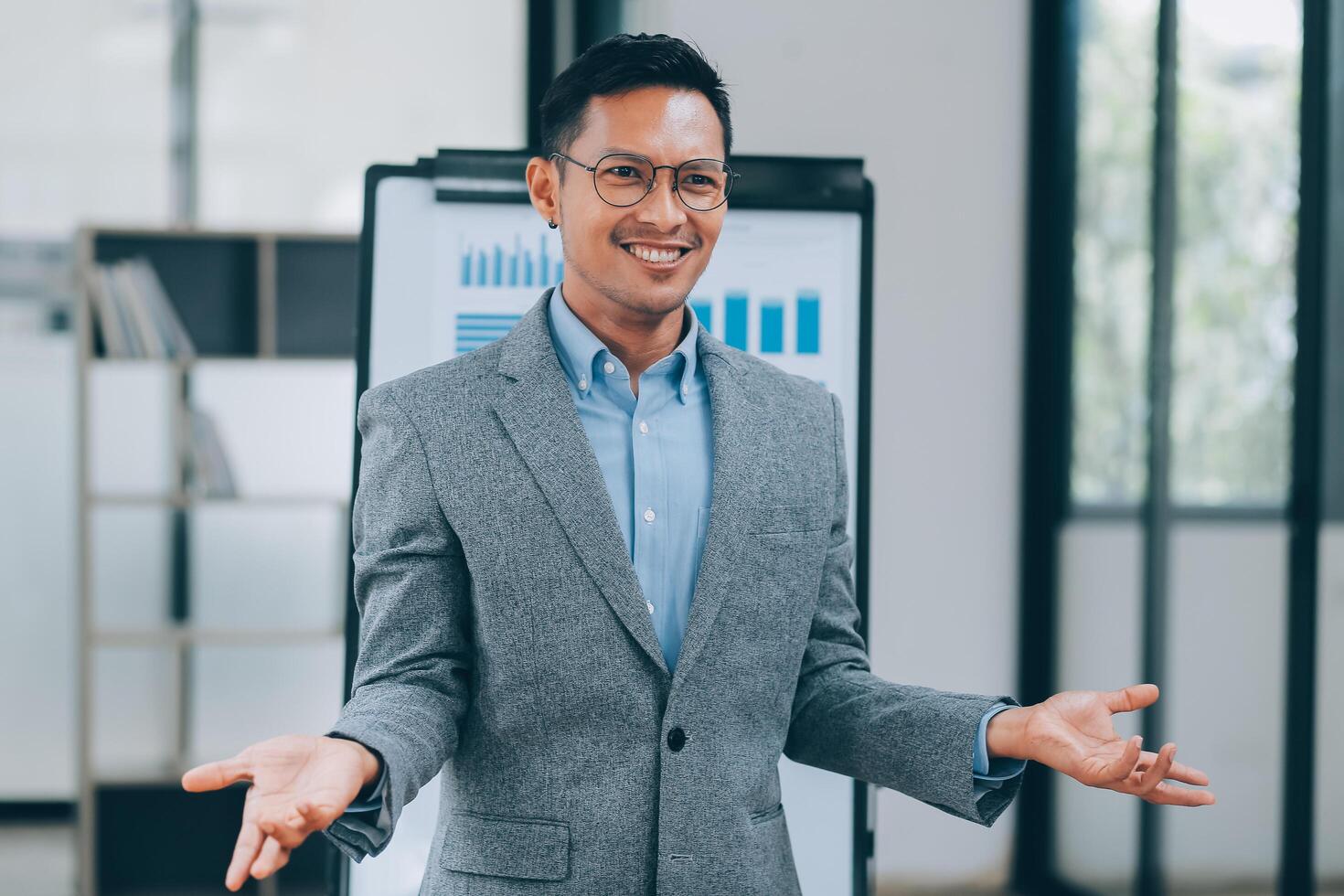 Young businessman giving presentation to his colleagues photo