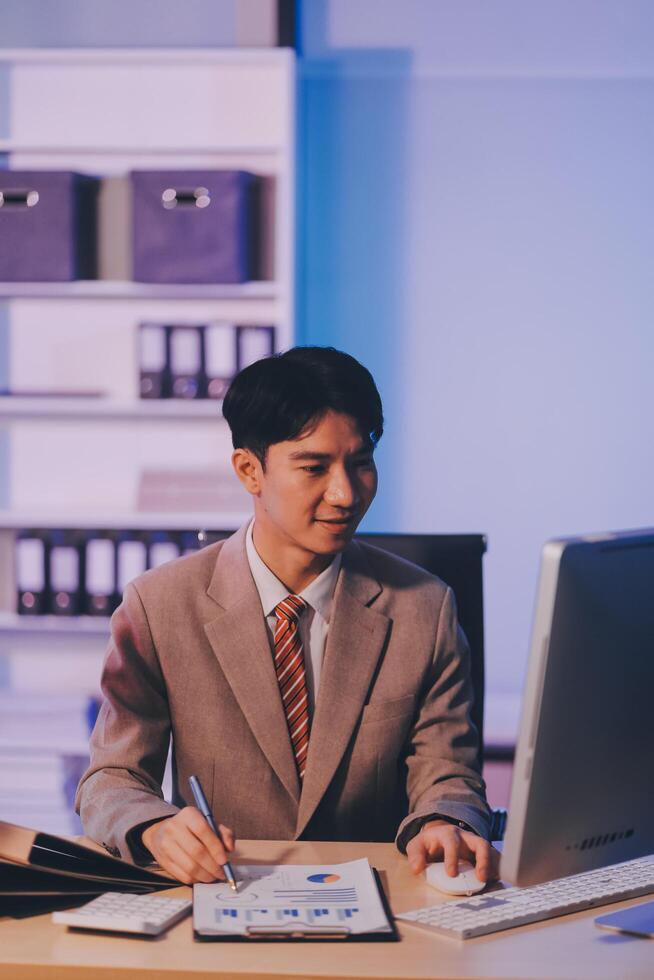 Businessman working hard overtime at night at the office. He felt tired and stressed from work. photo