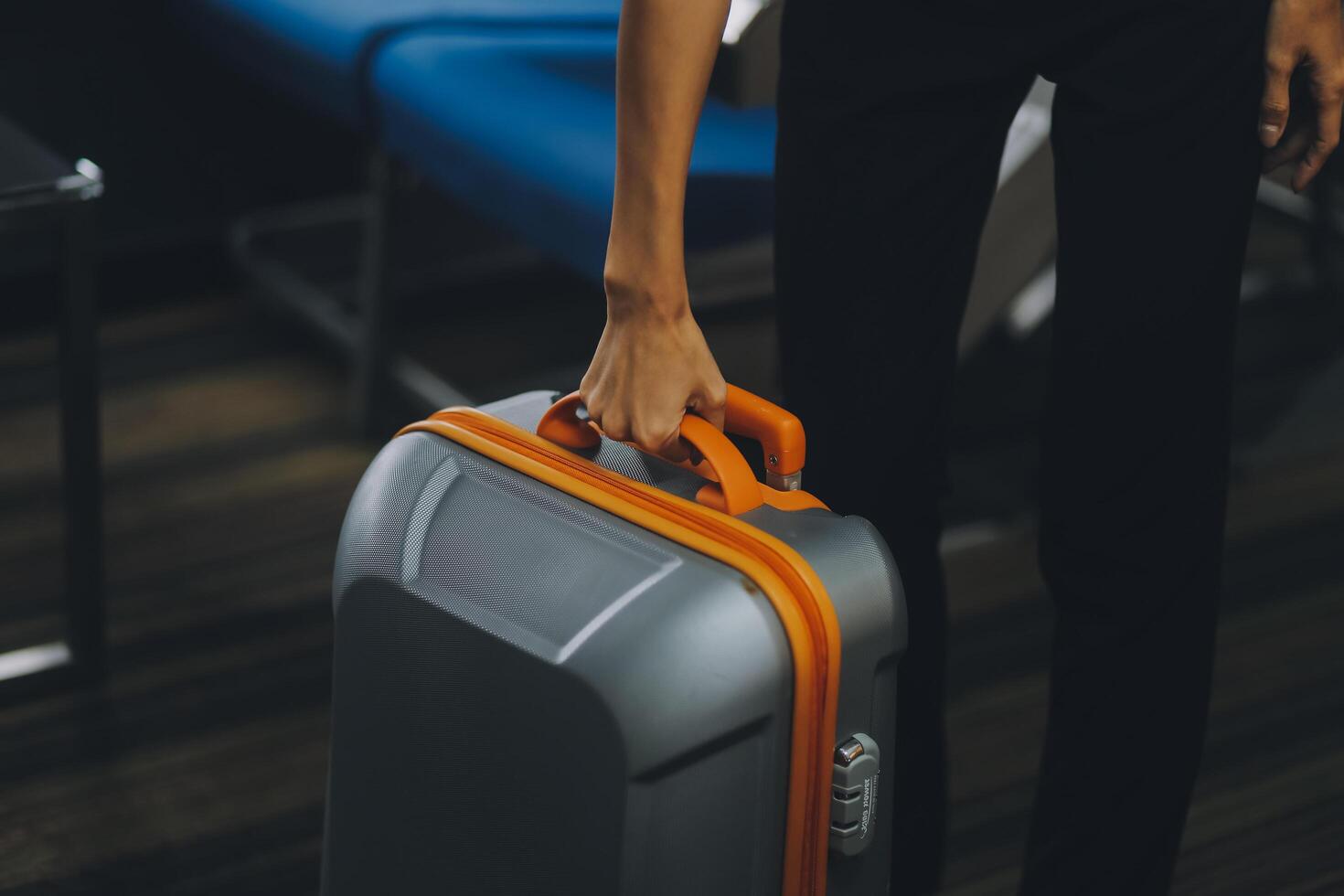 Young Female Tourist Storing Luggage in Overhead Compartment on Airplane During Travel photo