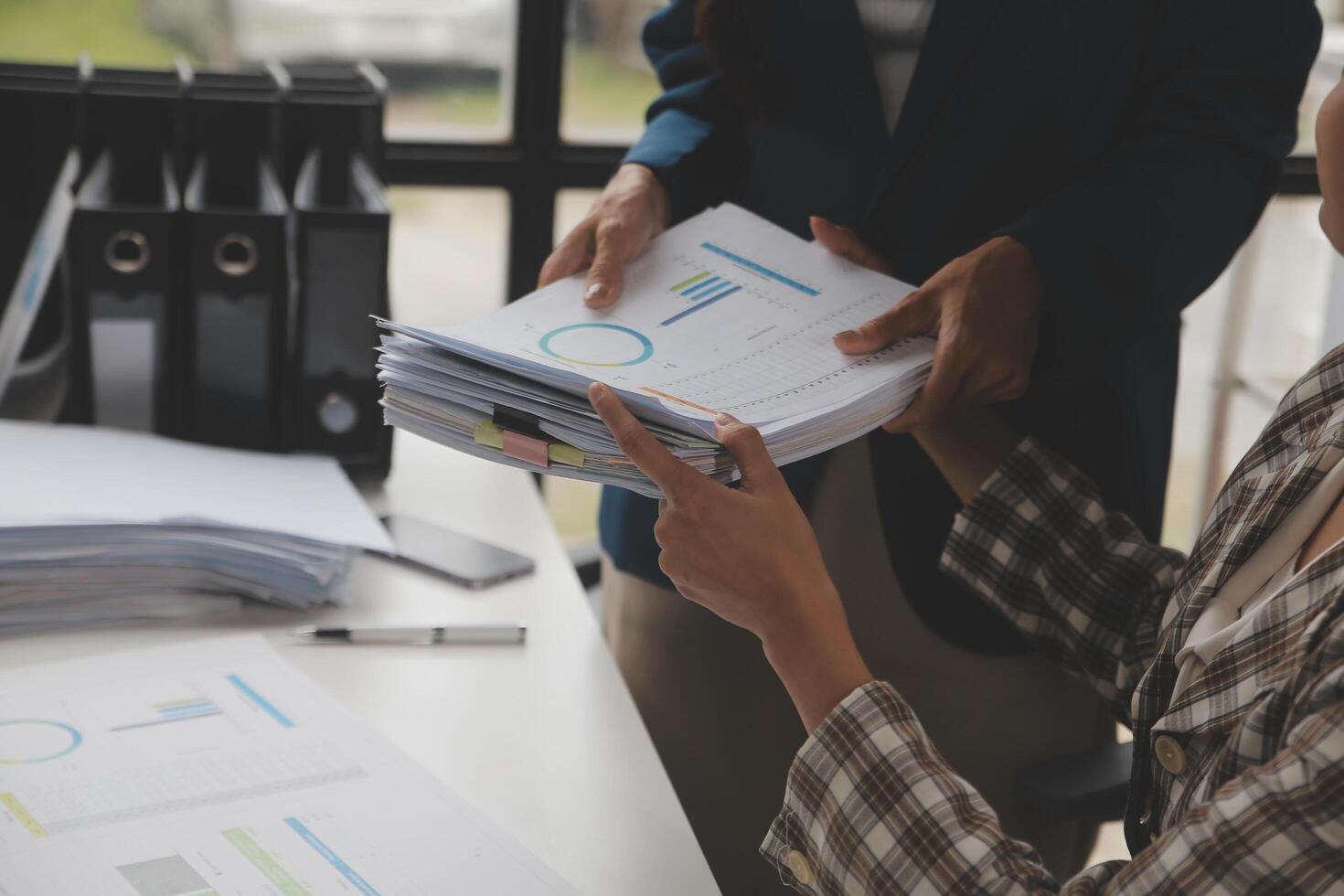 Group of confident business people point to graphs and charts to analyze market data, balance sheet, account, net profit to plan new sales strategies to increase production capacity. photo