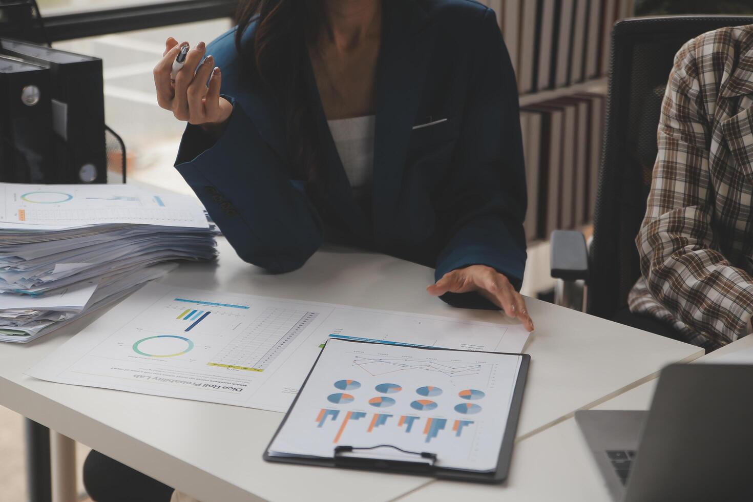 Group of confident business people point to graphs and charts to analyze market data, balance sheet, account, net profit to plan new sales strategies to increase production capacity. photo