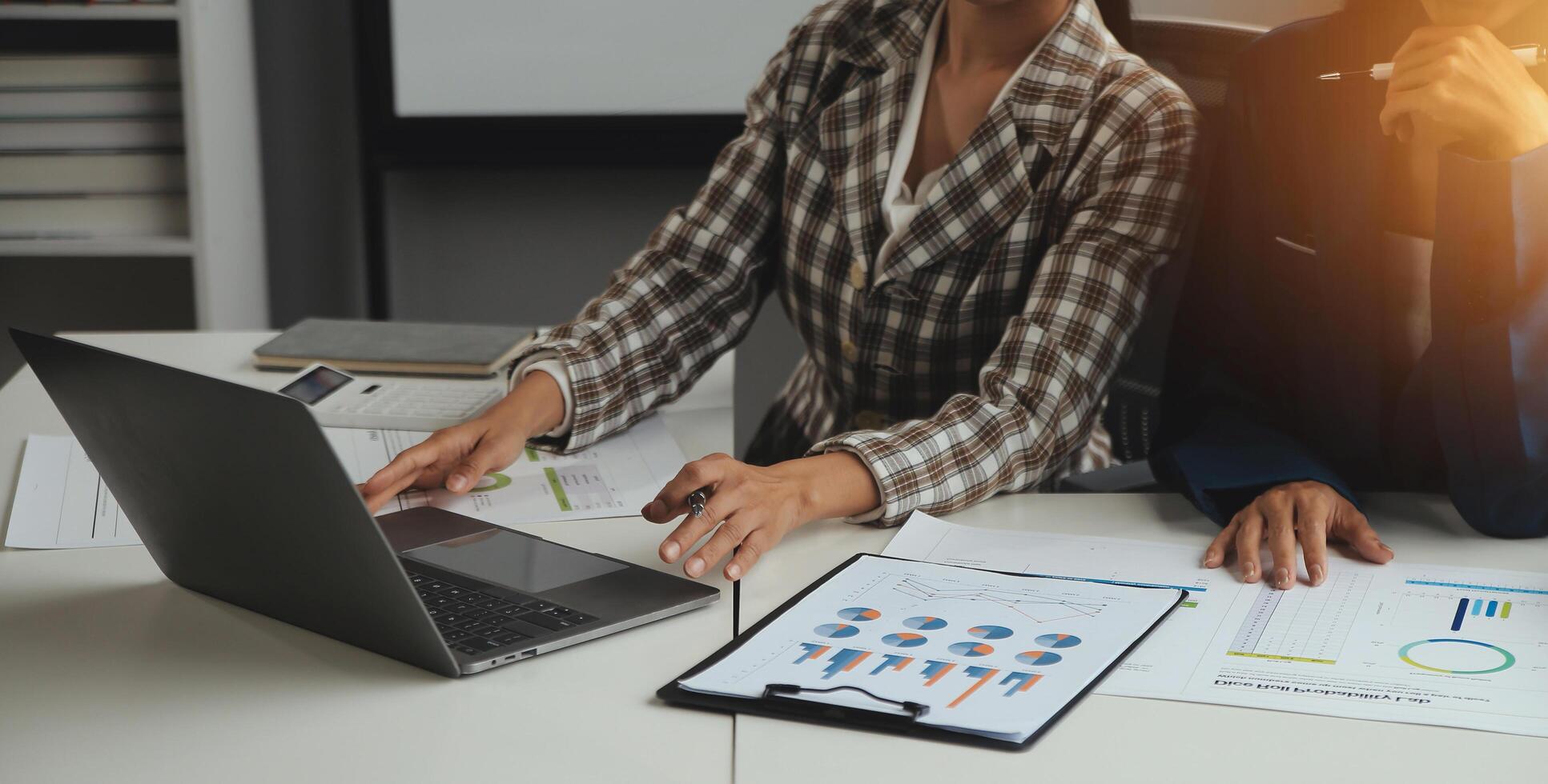 Group of confident business people point to graphs and charts to analyze market data, balance sheet, account, net profit to plan new sales strategies to increase production capacity. photo
