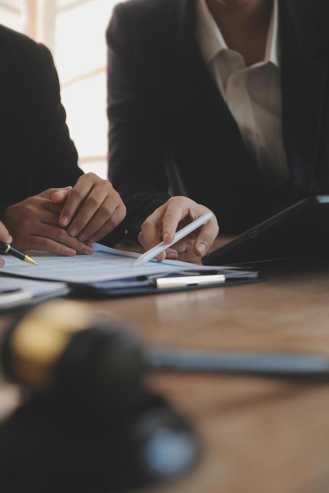 Lawyer, legal advisor, businessman brainstorming information on agreement details Business contracts in legal processing books for accuracy in contract documents. joint financial investment. photo