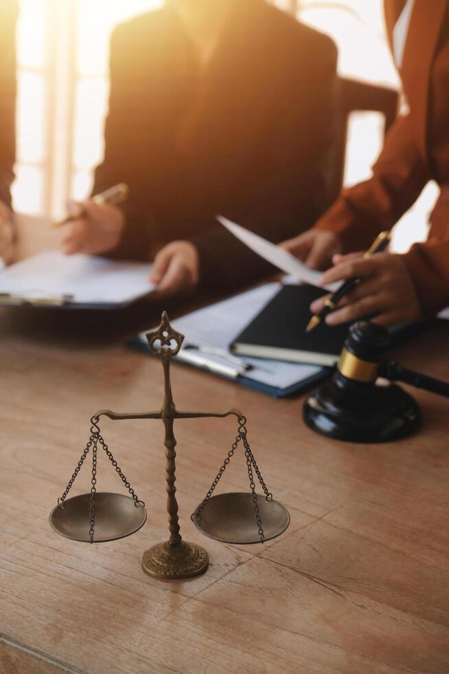 Lawyer, legal advisor, businessman brainstorming information on agreement details Business contracts in legal processing books for accuracy in contract documents. joint financial investment. photo