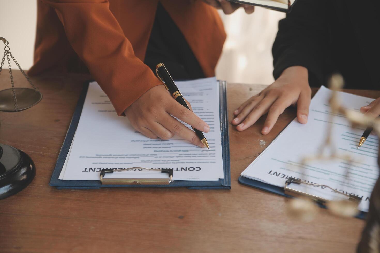 Lawyer, legal advisor, businessman brainstorming information on agreement details Business contracts in legal processing books for accuracy in contract documents. joint financial investment. photo