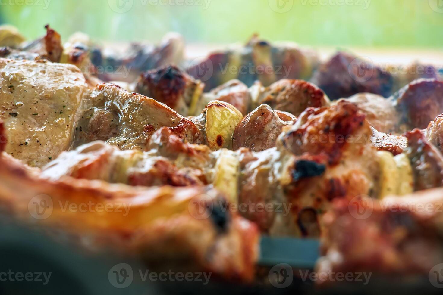 Cooking kebabs on a grill with smoke. Fresh brown BBQ meat cooked on an outdoor grill photo