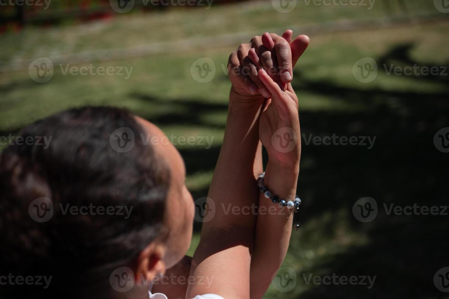 Close-up of clasped hands outdoors symbolizing connection and support photo