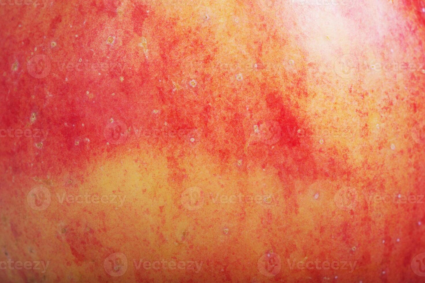 The texture of a red and yellow apple as a macro photo background.