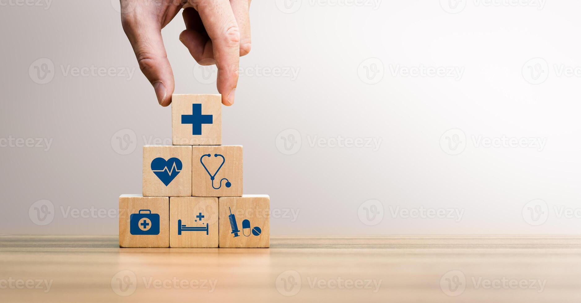 Health insurance concept, Hand Arranging Wooden Blocks with Medical Icons Including Heartbeat, Stethoscope, Syringe, and Healthcare Cross Symbol, Future Healthcare Technology photo