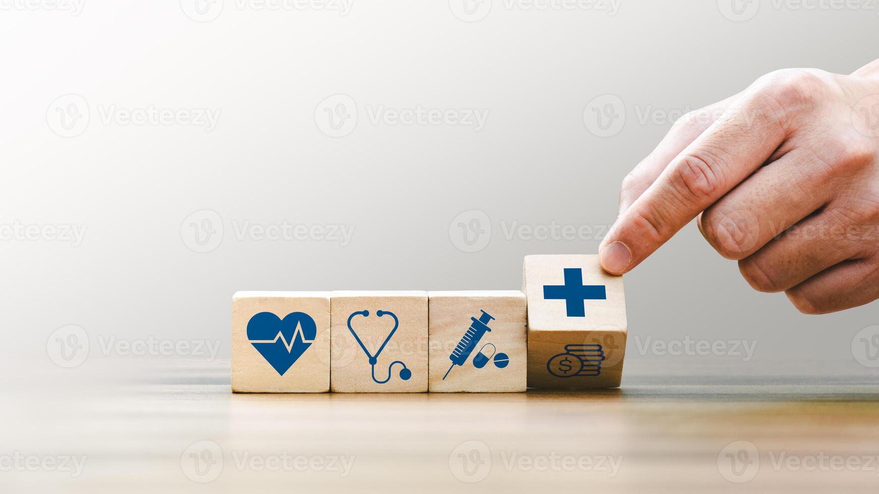 Health insurance concept, Hand Arranging Wooden Blocks with Medical Icons Including Heartbeat, Stethoscope, Syringe, and Healthcare Cross Symbol, Future Healthcare Technology photo