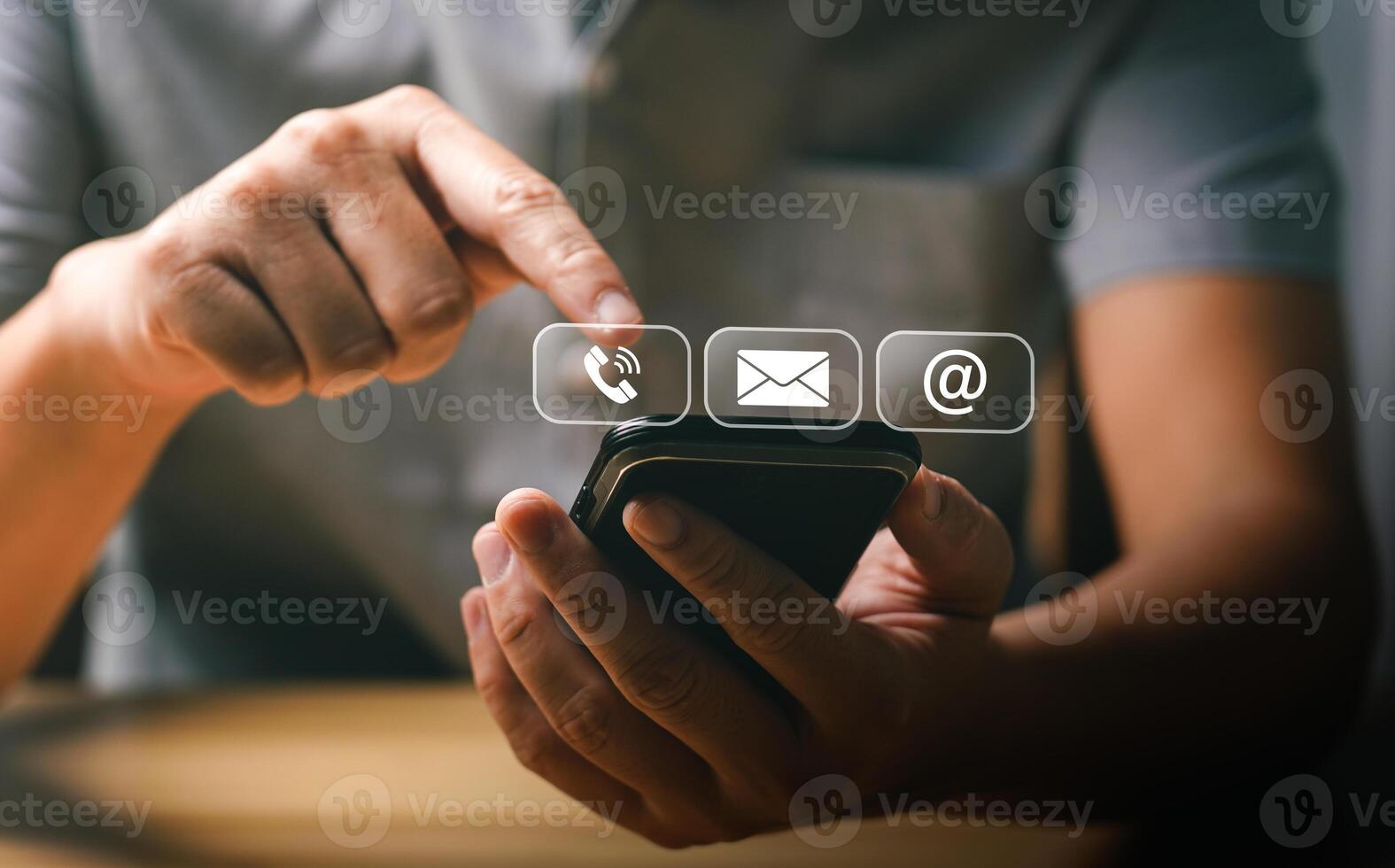 Man Using Smartphone to Access Communication Icons for Call, Email, and Internet, Representing Modern Digital Connectivity and Technology in Everyday Life photo