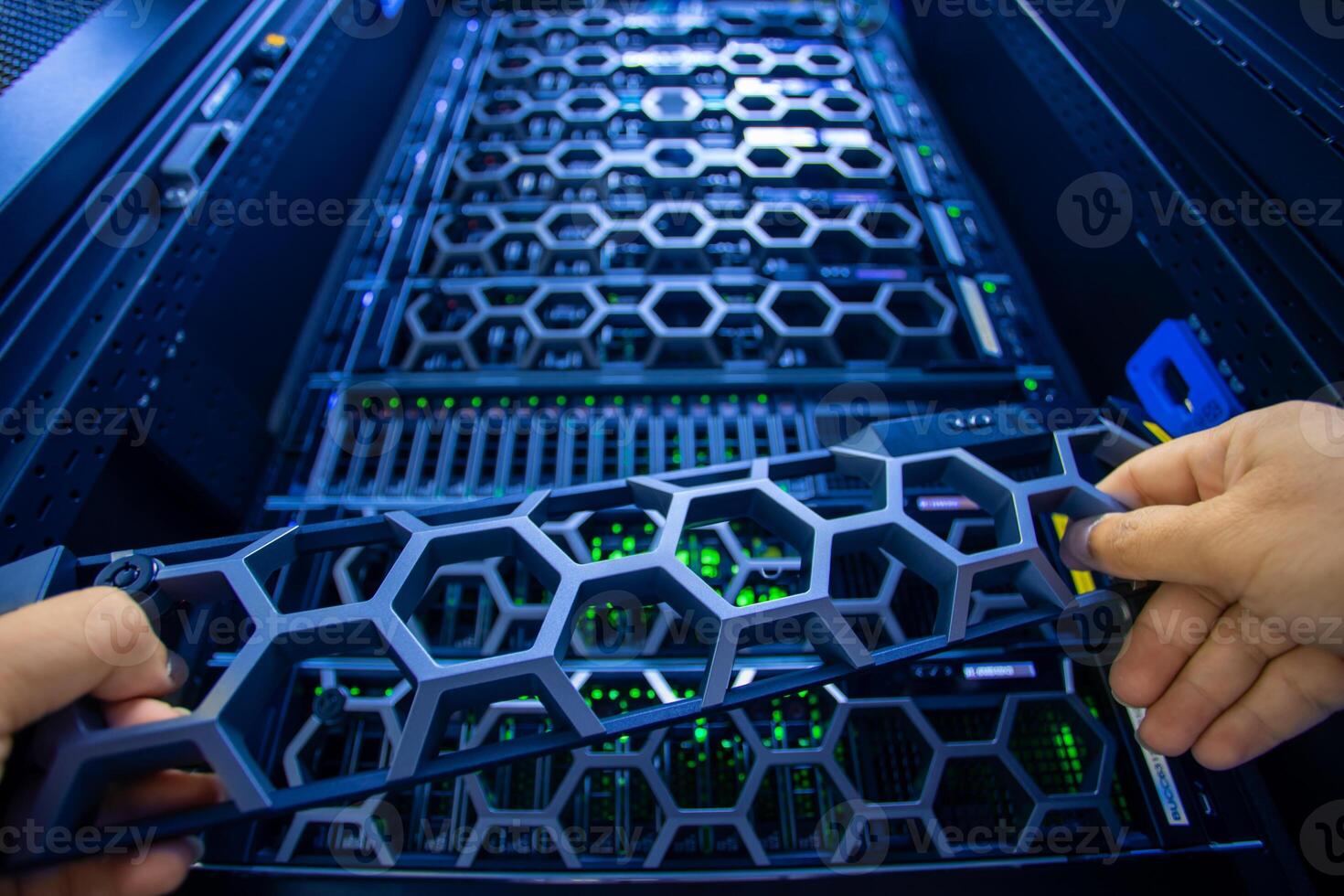 IT engineer repairing a server in a datacenter photo