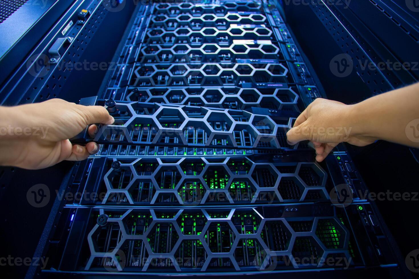 IT engineer repairing a server in a datacenter photo