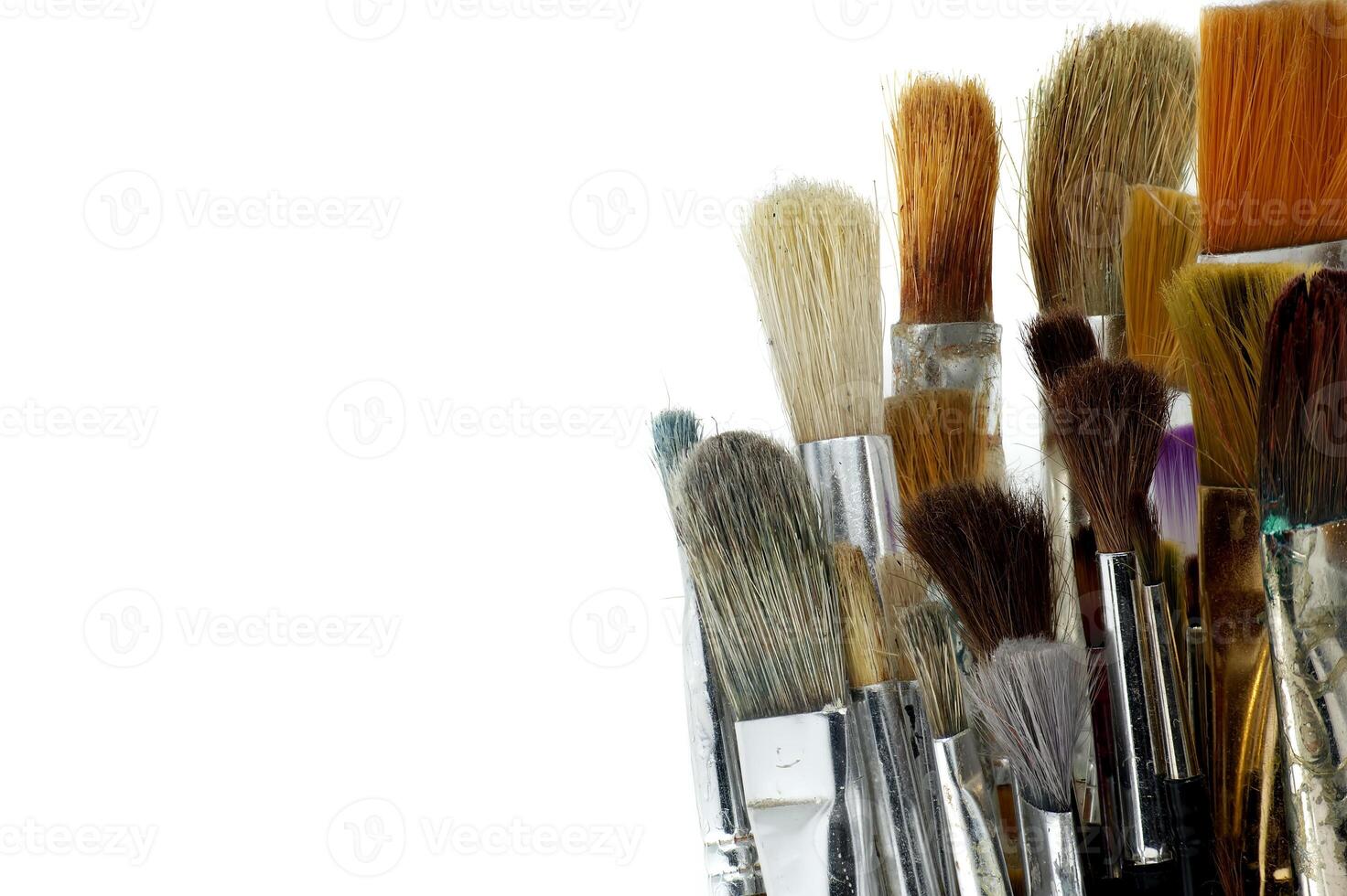 Array of paintbrushes of different sizes and colors isolated on white photo