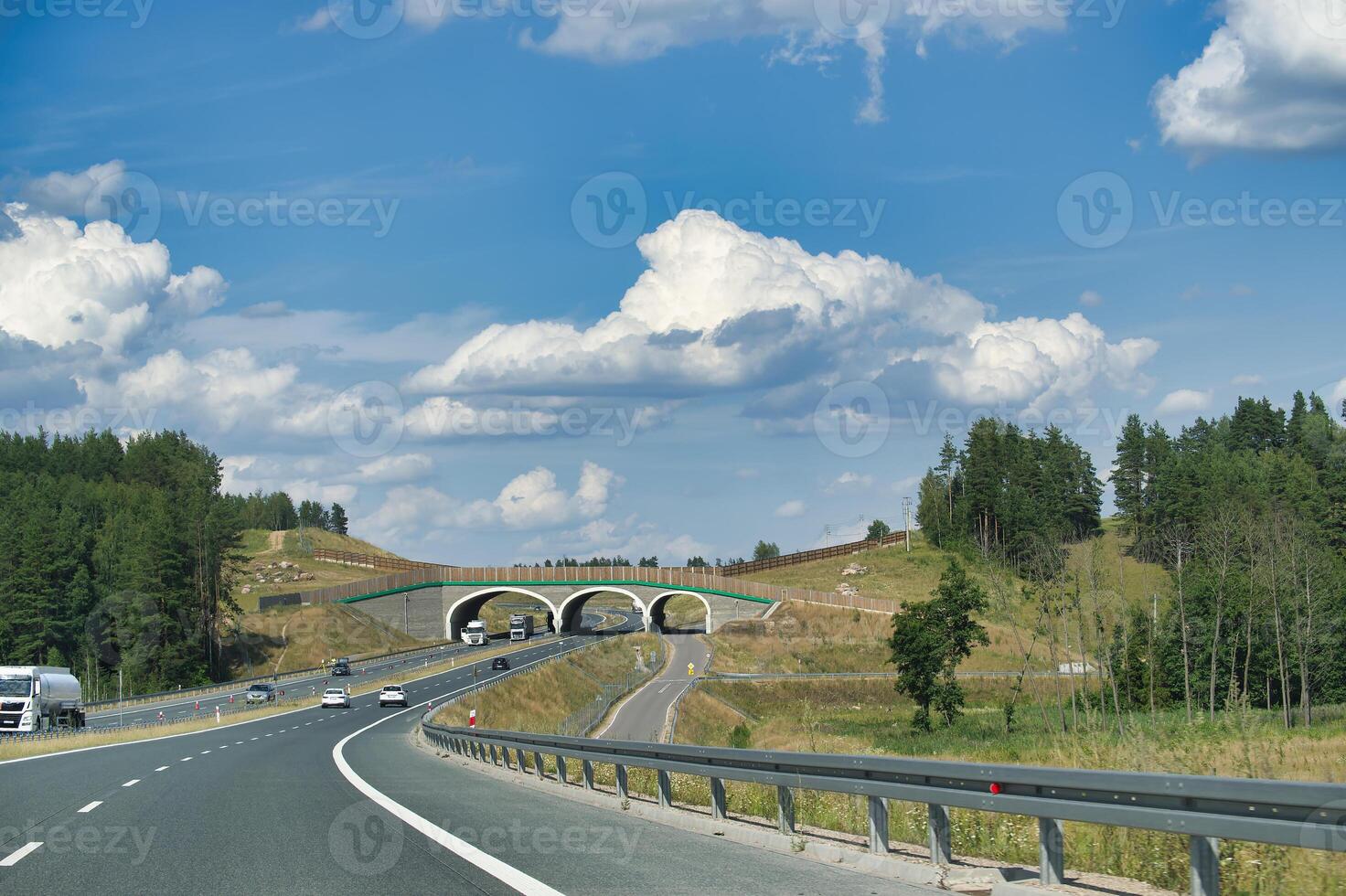 Scenic highway with overpass bridge and vehicles on a sunny day photo